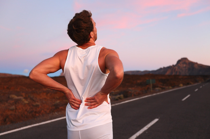 A person jogging on a road in Vancouver experiencing sciatica symptoms.